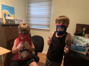 two kids modeling masks