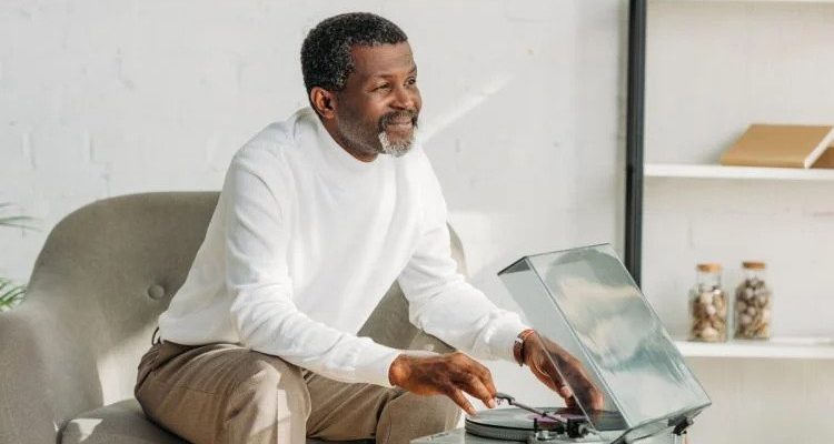 man sitting in front of record player